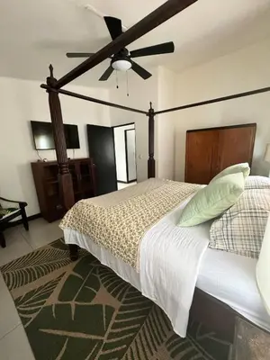 a bedroom with a bed with a ceiling fan at Beachfront Paradise in Tivives, Costa Rica - Your Home Away from Home in Tivives