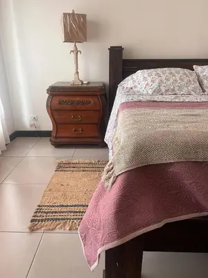 a bedroom with a bed and a table with a lamp at Beachfront Paradise in Tivives, Costa Rica - Your Home Away from Home in Tivives