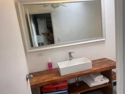 a bathroom with a white sink and a mirror at Beachfront Paradise in Tivives, Costa Rica - Your Home Away from Home in Tivives