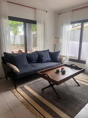 a living room with a blue couch and a coffee table at Beachfront Paradise in Tivives, Costa Rica - Your Home Away from Home in Tivives