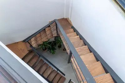 an overhead view of a set of stairs with a plant at Beach Mode Luxury 3-Story House in Tamarindo in Tamarindo