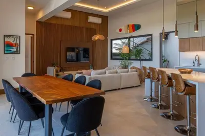 a living room with a couch and a table and chairs at Beach Mode Luxury 3-Story House in Tamarindo in Tamarindo