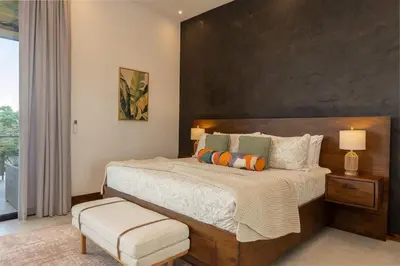a bedroom with a large bed and a large window at Beach Mode Luxury 3-Story House in Tamarindo in Tamarindo