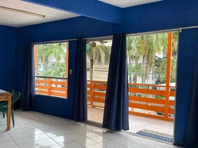 a room with blue walls and sliding glass doors at Beach Studio for 4 - AC - WiFi - Parking Santa Teresa in Santa Teresa