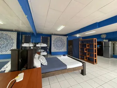 a room with three bunk beds and blue walls at Beach Studio for 4 - AC - WiFi - Parking Santa Teresa in Santa Teresa