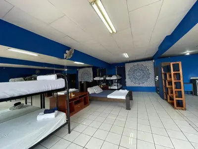 a room with three bunk beds and blue walls at Beach Studio for 4 - AC - WiFi - Parking Santa Teresa in Santa Teresa