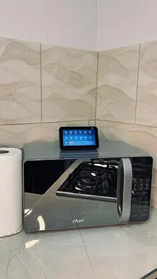 a tablet sitting on top of a stove in a kitchen at Ken lower apartment in Quepos