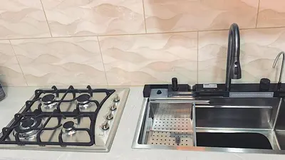a stove top oven sitting on top of a kitchen counter at Ken lower apartment in Quepos