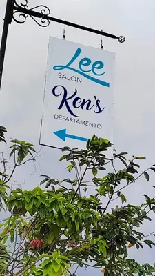 a sign hanging from a pole with a tree at Ken lower apartment in Quepos