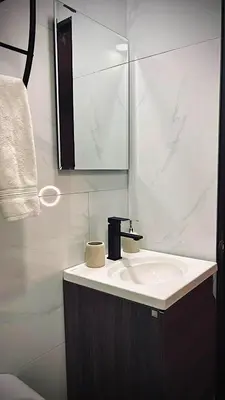 a bathroom with a sink and a mirror at Ken lower apartment in Quepos
