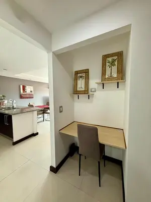 a kitchen and dining room with a wooden table at Escazu Guachipelin Peaceful Getaway, Pool, Wi-Fi & Work Space CR MARIPOSA RENTALS in San Rafael