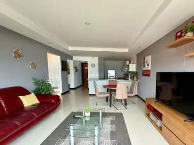 a living room with a red couch and a table at Escazu Guachipelin Peaceful Getaway, Pool, Wi-Fi & Work Space CR MARIPOSA RENTALS in San Rafael