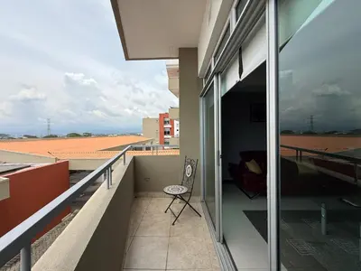 a balcony of a building with a chair on it at Escazu Guachipelin Peaceful Getaway, Pool, Wi-Fi & Work Space CR MARIPOSA RENTALS in San Rafael