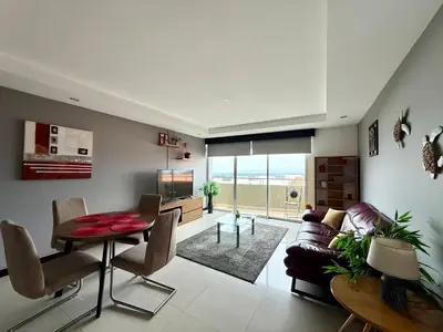 a living room with a table and a couch at Escazu Guachipelin Peaceful Getaway, Pool, Wi-Fi & Work Space CR MARIPOSA RENTALS in San Rafael
