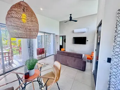 a living room with a couch and a table and chairs at Casa Bella 3 Bdrm House w Pool in Gated Community in Cuajiniquil
