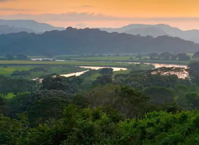 a view of a valley with a river and mountains at Casa Rural Los Almendros - Tarcoles in Capulín