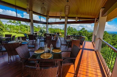 a restaurant with tables and chairs on a balcony at Hotel Sanctuarium in Fortuna