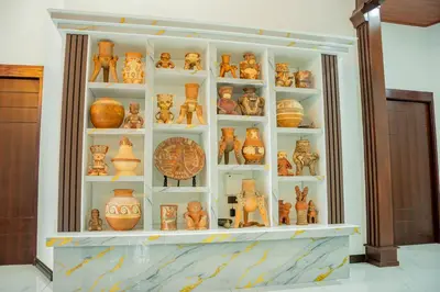 a display case filled with lots of pottery at Hotel Sanctuarium in Fortuna
