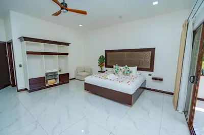 a large bedroom with a bed and a couch at Hotel Sanctuarium in Fortuna