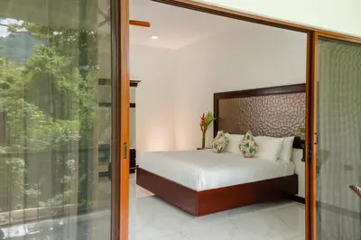 a bedroom with a bed and a sliding glass door at Hotel Sanctuarium in Fortuna