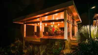 a house with a deck at night at Hotel Sanctuarium in Fortuna