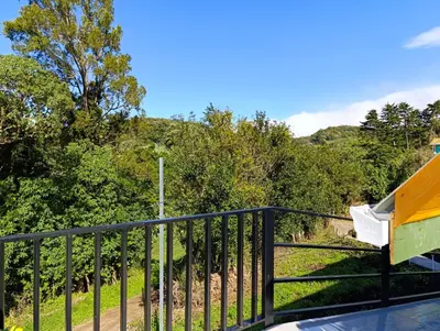 a view from the deck of a house with a fence at Cabaña El Trogon in Monteverde Costa Rica