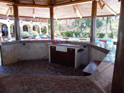 an outdoor kitchen with a sink in a pavilion at Rancho RachMare in Playa Coyote, a Beach Home! in Nandayure