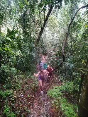 two people walking on a trail in the jungle at La Ceiba Biolgical Reserve in Platanillo