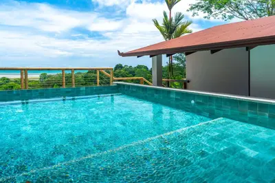 a swimming pool with a view of the ocean at NEW-Gated-Panoramic sunset ocean view-pool-4 suite in Ojochal
