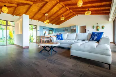 a living room with a couch and a table at NEW-Gated-Panoramic sunset ocean view-pool-4 suite in Ojochal