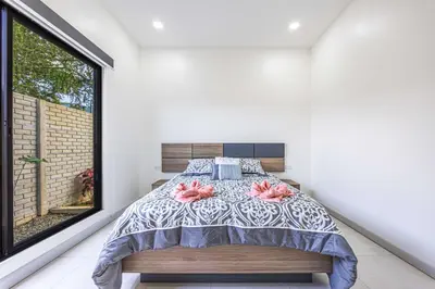a bedroom with a bed and a window at Uvita-New luxury-sleeps 6-private pool-huge patio in Uvita