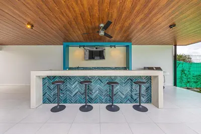 a counter with stools in a room with a ceiling at Uvita-New luxury-sleeps 6-private pool-huge patio in Uvita