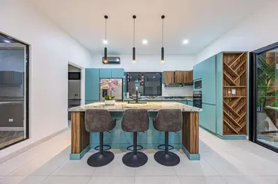 an open kitchen with a large island with bar stools at Uvita-New luxury-sleeps 6-private pool-huge patio in Uvita