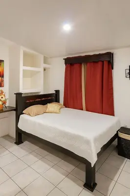 a bedroom with a bed with a red curtain at Vicky's Room - NO PARKING SITE in Santiago Este