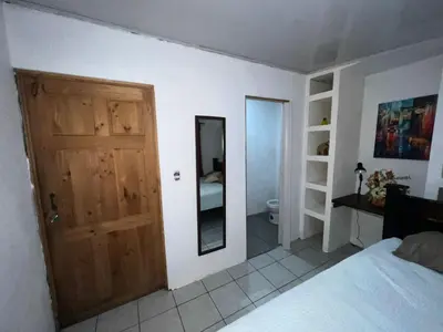 a bedroom with a wooden door and a mirror at Vicky's Room - NO PARKING SITE in Santiago Este