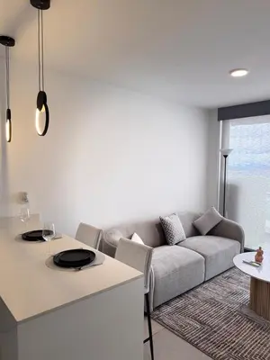 a living room with a couch and a table at Spectacular view and comfort from the 21st floor in San José