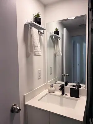 a bathroom with a sink and a large mirror at Spectacular view and comfort from the 21st floor in San José