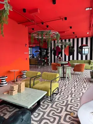 a room with red walls and tables and chairs at Spectacular view and comfort from the 21st floor in San José