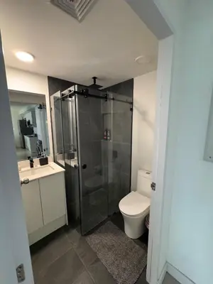 a bathroom with a shower and a toilet and a sink at Spectacular view and comfort from the 21st floor in San José