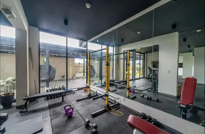 a gym with a large mirror and some equipment at Spectacular view and comfort from the 21st floor in San José