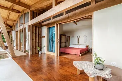 a bedroom with a red bed and a table at 3 Rooms Salt pool Star Link 4 min To Santa in Cóbano