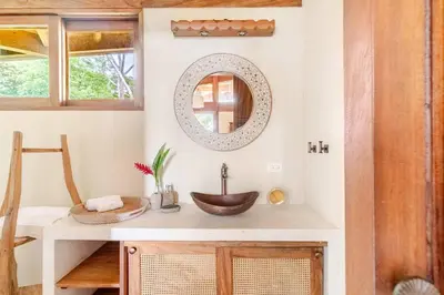 a bathroom with a sink and a mirror at 3 Rooms Salt pool Star Link 4 min To Santa in Cóbano