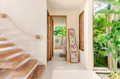 a staircase in a house with wooden steps at 3 Rooms Salt pool Star Link 4 min To Santa in Cóbano