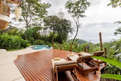 a wooden deck with chairs and a swimming pool at 3 Rooms Salt pool Star Link 4 min To Santa in Cóbano