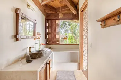 a bathroom with a sink and a window at 3 Rooms Salt pool Star Link 4 min To Santa in Cóbano