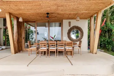 a dining room with a wooden table and chairs at 3 Rooms Salt pool Star Link 4 min To Santa in Cóbano