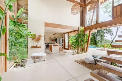 an open living room with plants and a kitchen at 3 Rooms Salt pool Star Link 4 min To Santa in Cóbano