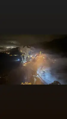 a view of a city lit up at night at Mountain Retreat Refugio de Aves in Turrialba