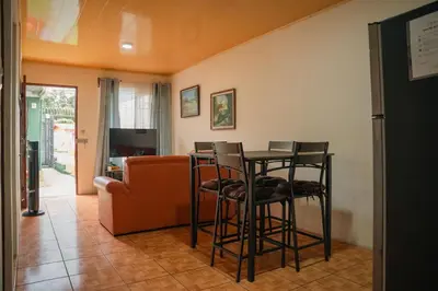 a living room with a table and chairs and a couch at 5-minute walk downtown apartment in Fortuna