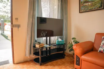 a living room with a television and a couch at 5-minute walk downtown apartment in Fortuna